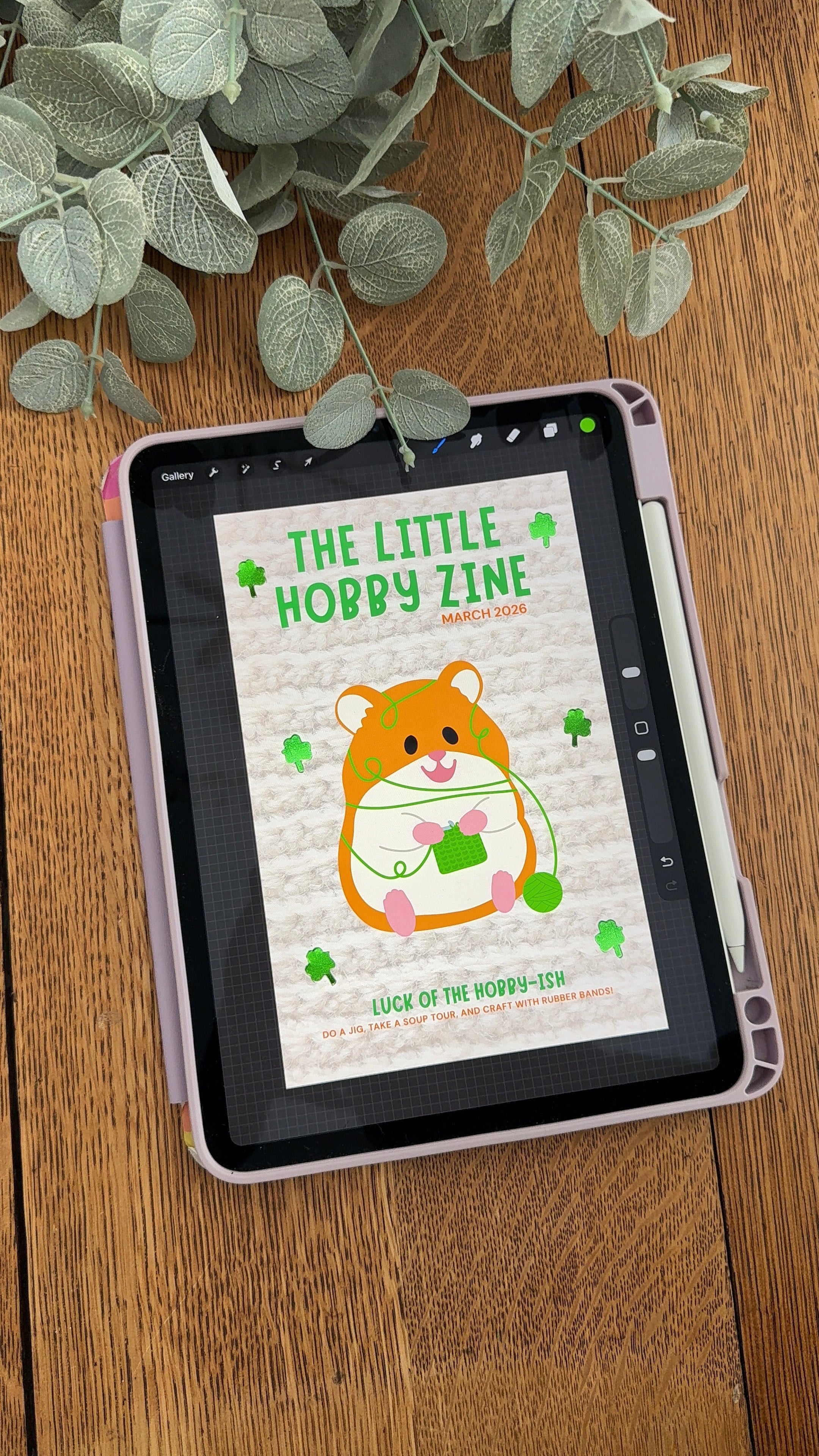 Digital magazine titled 'The Little Hobby Zine' on a tablet with a plant in the background