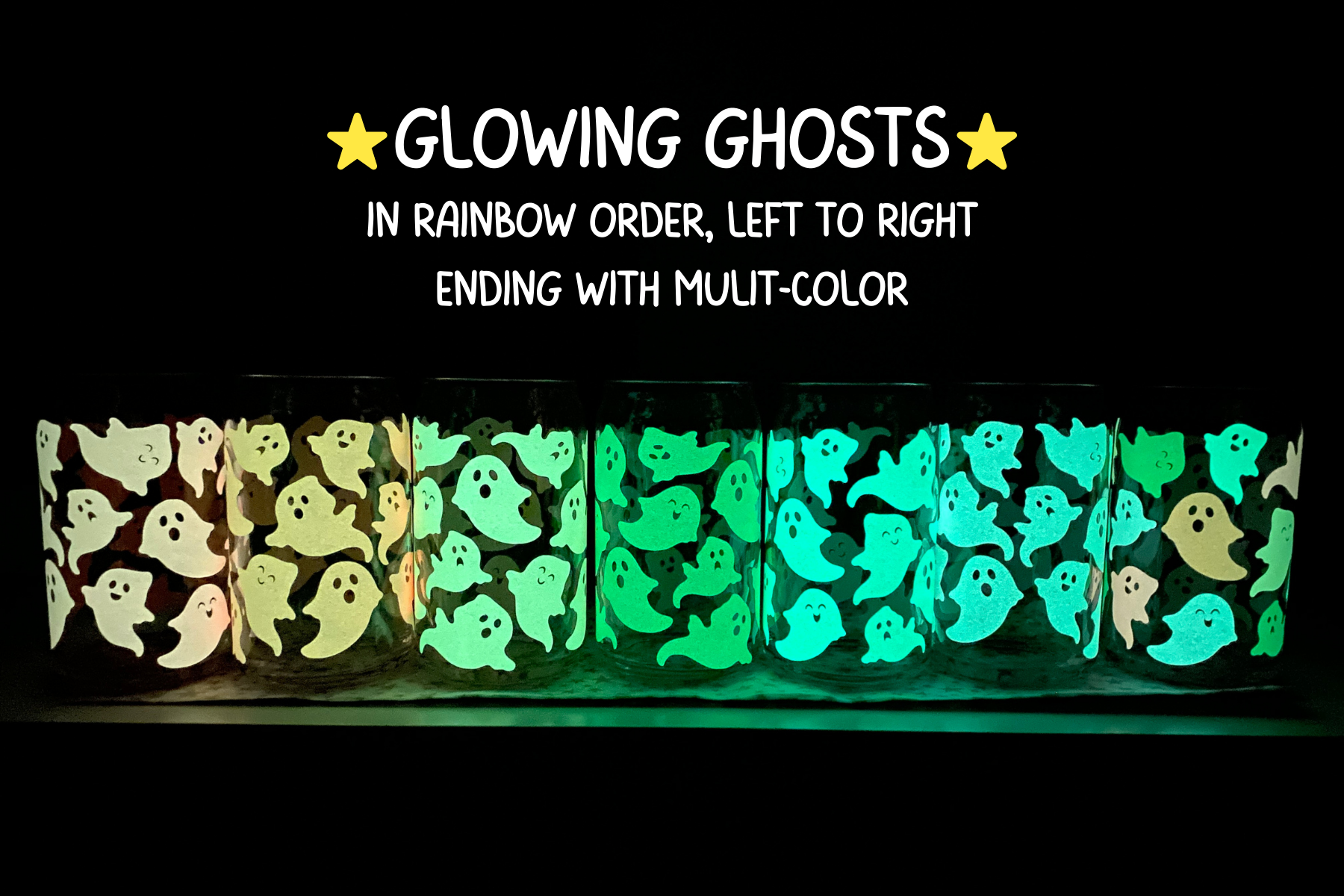 Glass cans covered in glowing rainbow ghosts glowing in the dark on a table.