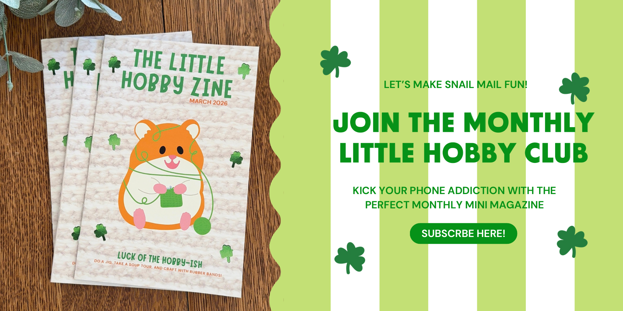 Three copies of 'The Little Hobby Zine' with a promotional banner for the monthly club on a wooden surface.